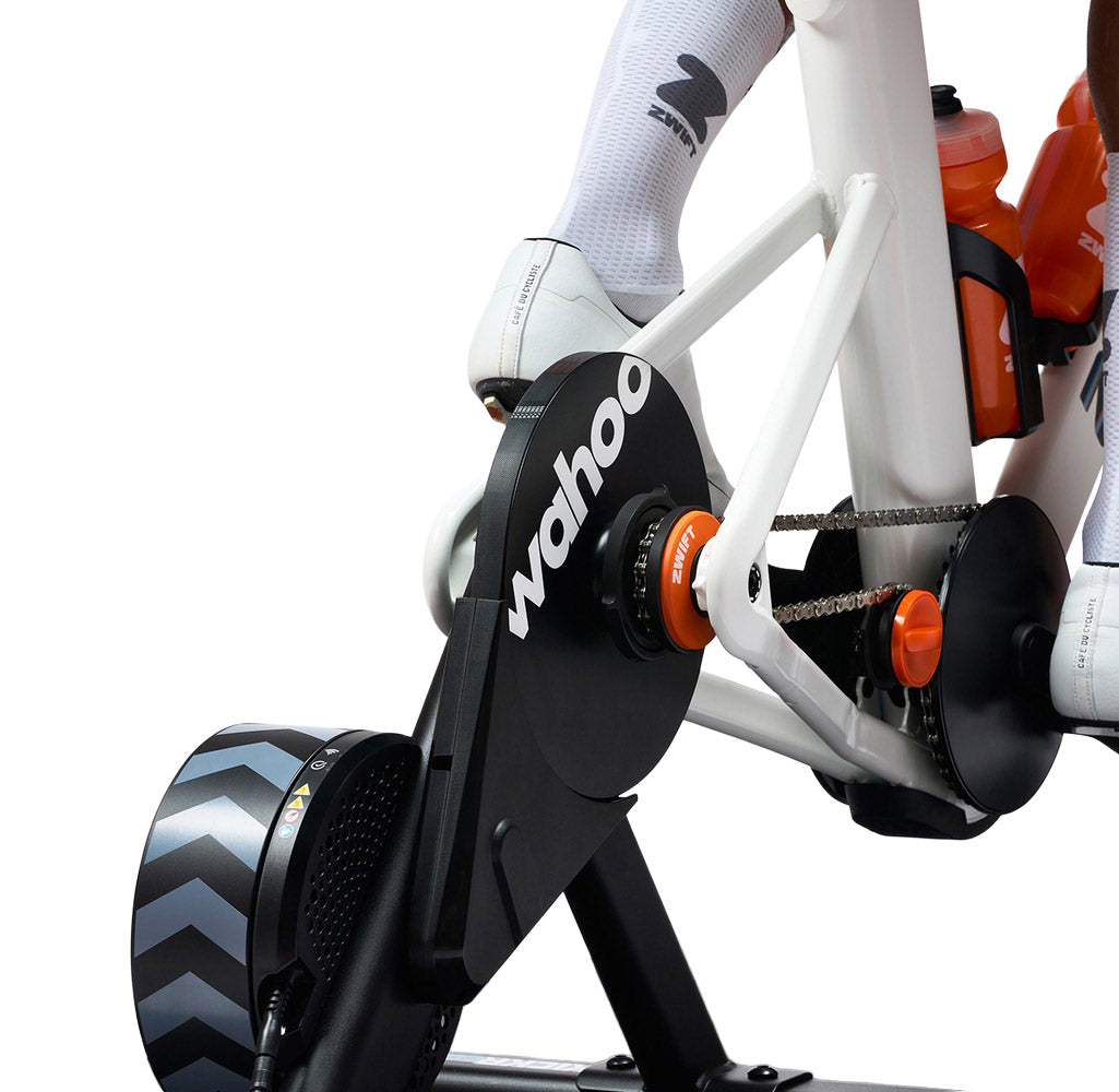 Close-up of a Wahoo smart trainer with Zwift cog, attached to a zwift frame on a white background

